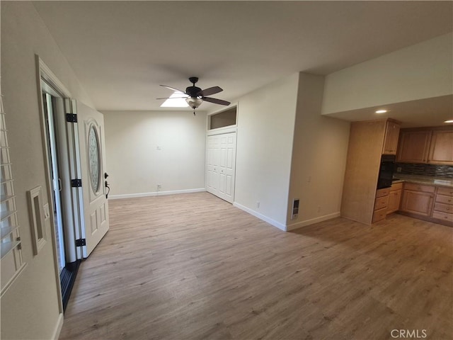 1501 Pelham Rd Unit 127J, Seal Beach, CA 90740 - unfurnished living room with light wood-style floors, a ceiling fan, and recessed lighting
