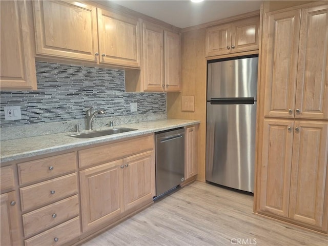 1501 Pelham Rd Unit 127J, Seal Beach, CA 90740 - kitchen featuring stainless steel appliances, light brown cabinetry, backsplash, light wood-style flooring, and light stone countertops