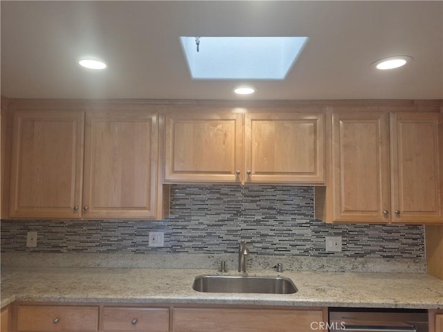 1501 Pelham Rd Unit 127J, Seal Beach, CA 90740 - kitchen featuring a skylight, light brown cabinetry, tasteful backsplash, and light stone counters
