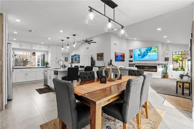 25891 Pinewood Ln, Laguna Hills, CA 92653 - dining space featuring vaulted ceiling, recessed lighting, a glass covered fireplace, and ceiling fan