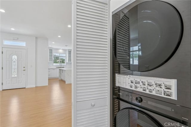 17148 Stare St, Northridge, CA 91325 - laundry room featuring stacked washer / drying machine, light wood finished floors, and recessed lighting