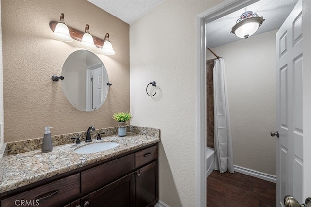 44112 Precise St, Lancaster, CA 93536 - full bathroom with vanity, wood finished floors, and shower / bath combo with shower curtain