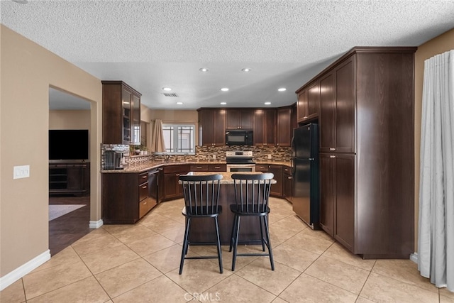 44112 Precise St, Lancaster, CA 93536 - kitchen featuring black appliances, decorative backsplash, dark brown cabinetry, a textured ceiling, and a kitchen island