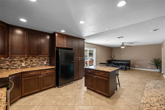 44112 Precise St, Lancaster, CA 93536 - kitchen with freestanding refrigerator, a ceiling fan, backsplash, light tile patterned flooring, and open floor plan