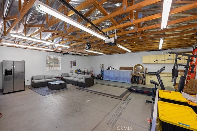 44112 Precise St, Lancaster, CA 93536 - garage with stainless steel fridge and a garage door opener