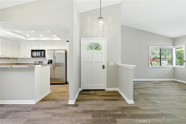 24571 Camden Ct, Laguna Niguel, CA 92677 - entryway with light wood finished floors, recessed lighting, a raised ceiling, and high vaulted ceiling
