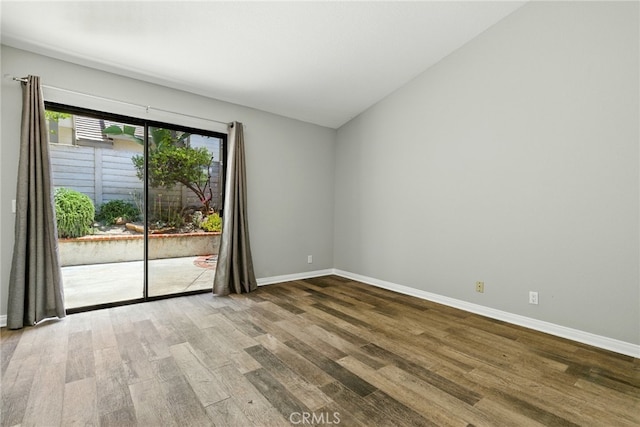 24571 Camden Ct, Laguna Niguel, CA 92677 - spare room featuring wood finished floors and vaulted ceiling