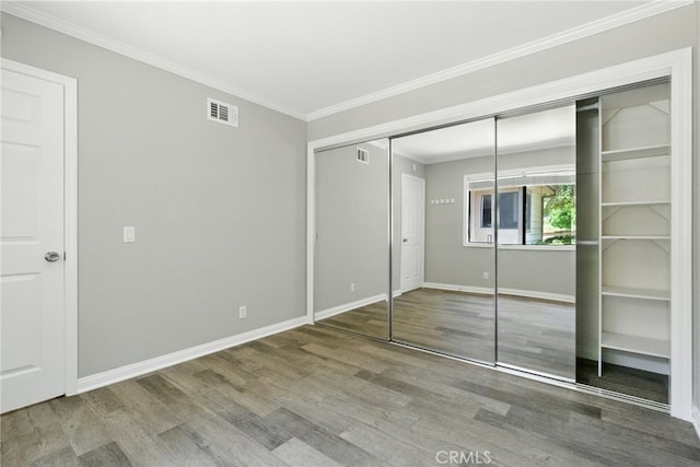 24571 Camden Ct, Laguna Niguel, CA 92677 - unfurnished bedroom with wood finished floors, ornamental molding, and a closet