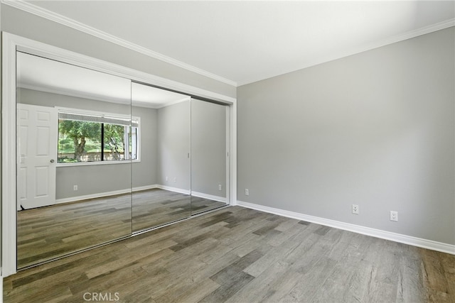 24571 Camden Ct, Laguna Niguel, CA 92677 - unfurnished bedroom with wood finished floors, a closet, and crown molding