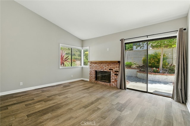 24571 Camden Ct, Laguna Niguel, CA 92677 - unfurnished living room featuring wood finished floors, lofted ceiling, and a fireplace