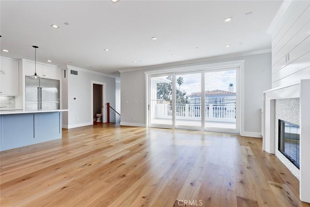 1100 Cypress Ave, Hermosa Beach, CA 90254 - unfurnished living room with ornamental molding, a tile fireplace, light wood-type flooring, and recessed lighting
