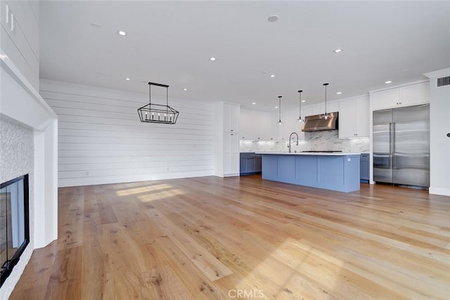 1100 Cypress Ave, Hermosa Beach, CA 90254 - unfurnished living room featuring light wood-type flooring, recessed lighting, and a glass covered fireplace