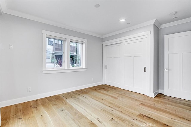 1100 Cypress Ave, Hermosa Beach, CA 90254 - unfurnished bedroom with crown molding, light wood finished floors, and a closet