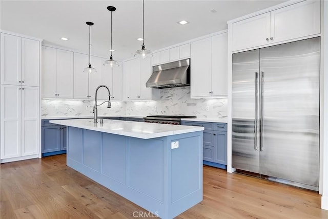 1100 Cypress Ave, Hermosa Beach, CA 90254 - kitchen featuring built in refrigerator, under cabinet range hood, light wood-style floors, backsplash, and recessed lighting
