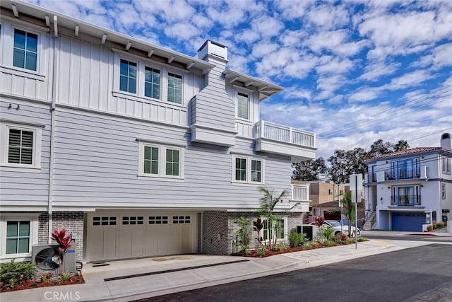 1100 Cypress Ave, Hermosa Beach, CA 90254 - townhome / multi-family property featuring brick siding, a chimney, a garage, and board and batten siding