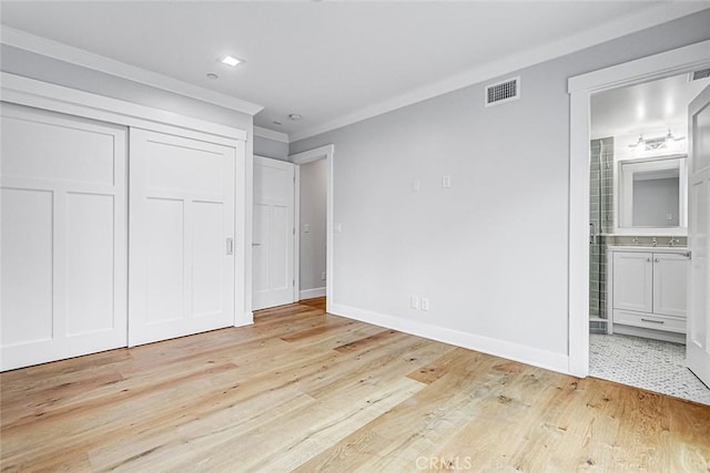 1100 Cypress Ave, Hermosa Beach, CA 90254 - unfurnished bedroom featuring light wood finished floors, crown molding, a closet, and ensuite bath