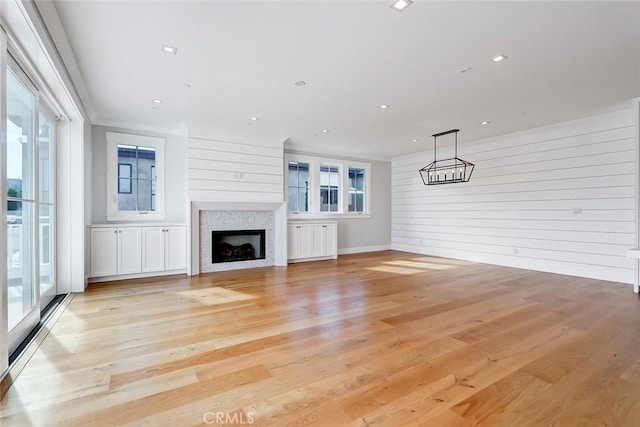 1100 Cypress Ave, Hermosa Beach, CA 90254 - unfurnished living room featuring plenty of natural light, wood walls, light wood-style floors, a fireplace, and recessed lighting