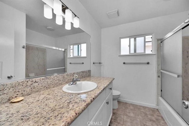 5495 N Callisch Ave, Fresno, CA 93710 - full bathroom featuring vanity, bath / shower combo with glass door, and tile patterned floors
