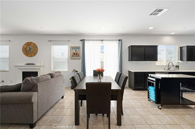 3660 Half Dome Ave, Rosamond, CA 93560 - dining space featuring healthy amount of natural light, light tile patterned floors, recessed lighting, and a warm lit fireplace