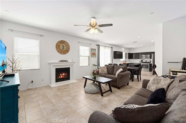 3660 Half Dome Ave, Rosamond, CA 93560 - living area with a ceiling fan, a lit fireplace, light tile patterned floors, and recessed lighting
