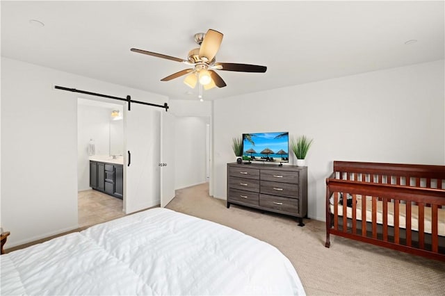 3660 Half Dome Ave, Rosamond, CA 93560 - bedroom featuring a barn door, light colored carpet, and ceiling fan