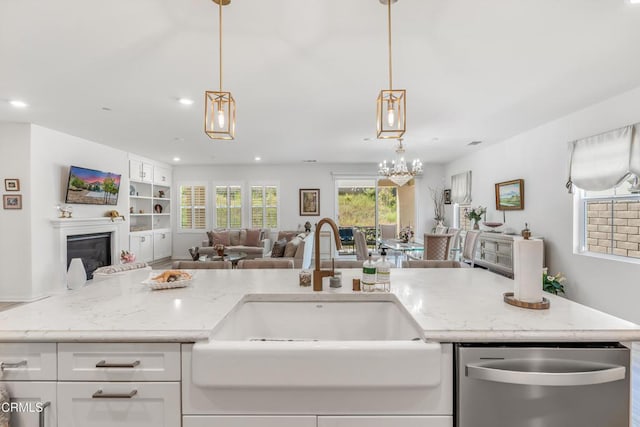 566 Purple Sage Ln, Simi Valley, CA 93065 - kitchen with dishwasher, open floor plan, light stone countertops, a glass covered fireplace, and recessed lighting