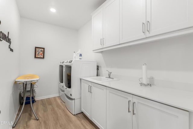 566 Purple Sage Ln, Simi Valley, CA 93065 - washroom featuring cabinet space, washing machine and dryer, light wood-type flooring, and recessed lighting