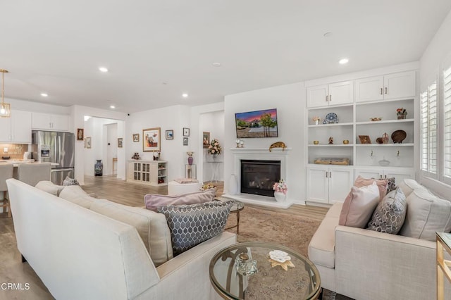 566 Purple Sage Ln, Simi Valley, CA 93065 - living room with recessed lighting, light wood-type flooring, and a glass covered fireplace