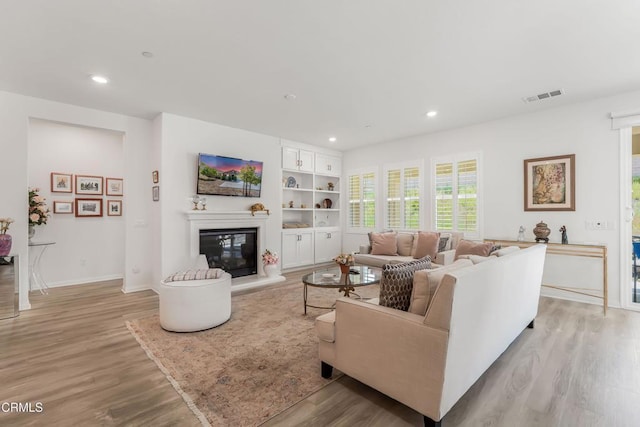 566 Purple Sage Ln, Simi Valley, CA 93065 - living room with light wood-style floors, recessed lighting, and a glass covered fireplace