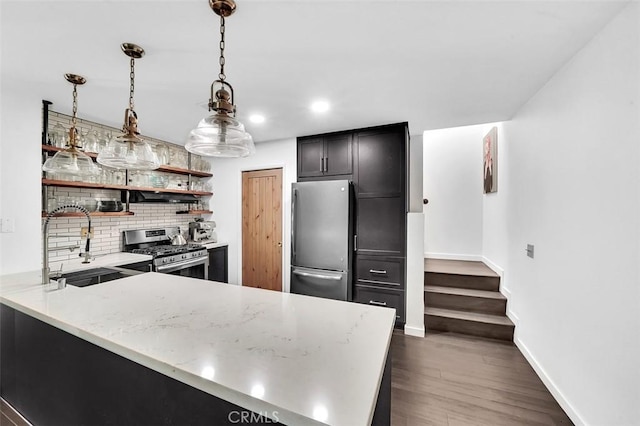 645 Springbrook, Irvine, CA 92614 - kitchen with appliances with stainless steel finishes, backsplash, recessed lighting, light stone countertops, and a peninsula