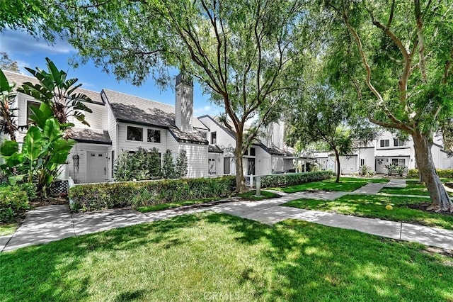 645 Springbrook, Irvine, CA 92614 - view of front facade featuring a chimney, a front lawn, and a residential view