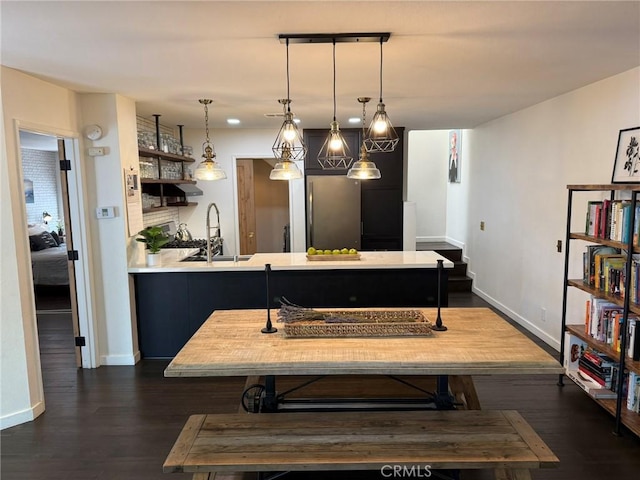 645 Springbrook N Unit 21, Irvine, CA 92614 - dining space featuring baseboards and dark wood-style floors