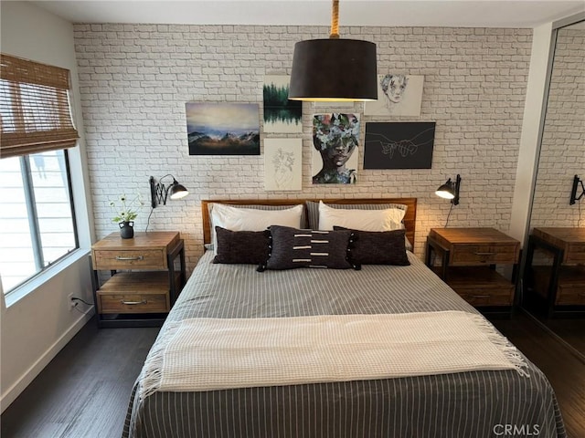 645 Springbrook N Unit 21, Irvine, CA 92614 - bedroom with dark wood finished floors and brick wall