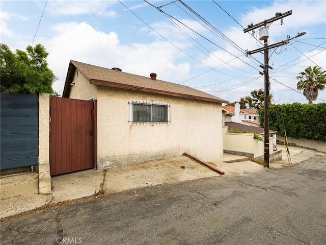 512 Lomita St, El Segundo, CA 90245 - view of property exterior featuring stucco siding and a gate