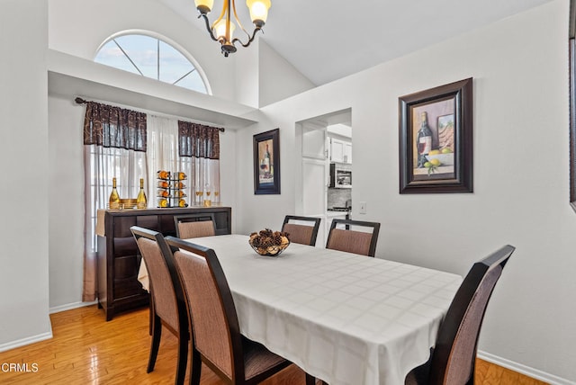 1306 Bluejay St, Fillmore, CA 93015 - dining space featuring a chandelier, light wood finished floors, and vaulted ceiling