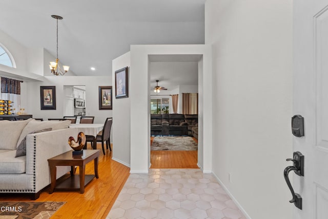 1306 Bluejay St, Fillmore, CA 93015 - living room with a chandelier, ceiling fan, vaulted ceiling, recessed lighting, and light wood-style floors