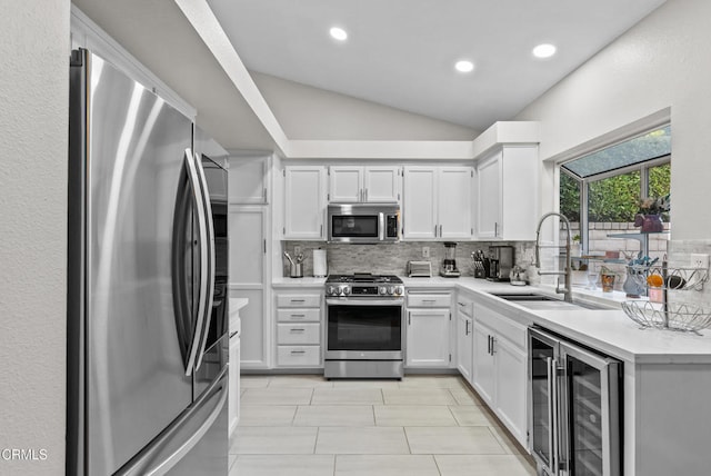 1306 Bluejay St, Fillmore, CA 93015 - kitchen with stainless steel appliances, wine cooler, vaulted ceiling, tasteful backsplash, and light countertops