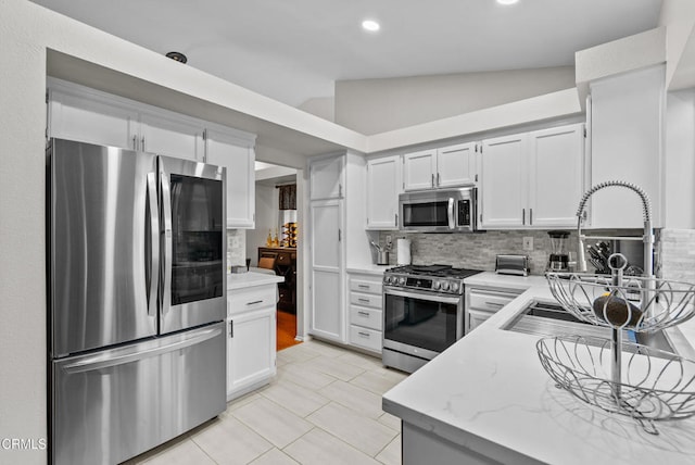 1306 Bluejay St, Fillmore, CA 93015 - kitchen featuring stainless steel appliances, backsplash, light tile patterned floors, recessed lighting, and lofted ceiling