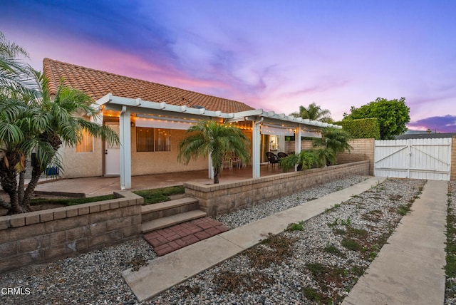 1306 Bluejay St, Fillmore, CA 93015 - rear view of property featuring a gate, a tiled roof, a patio area, and stucco siding