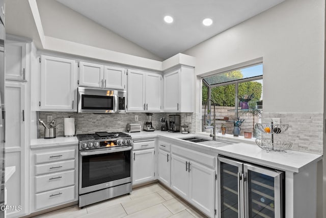 1306 Bluejay St, Fillmore, CA 93015 - kitchen featuring appliances with stainless steel finishes, beverage cooler, lofted ceiling, light countertops, and backsplash