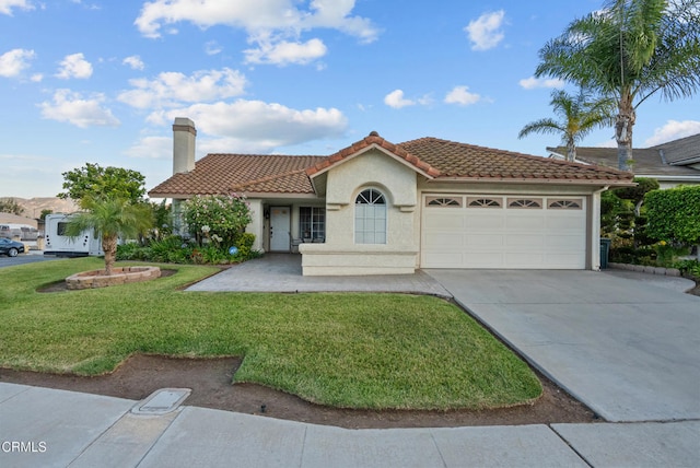 1306 Bluejay St, Fillmore, CA 93015 - mediterranean / spanish-style home with a tile roof, a garage, concrete driveway, a front lawn, and stucco siding