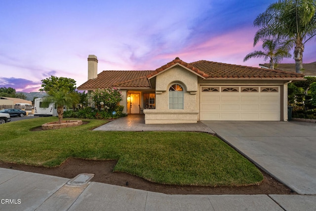 1306 Bluejay St, Fillmore, CA 93015 - mediterranean / spanish-style house with a garage, concrete driveway, a tile roof, a lawn, and stucco siding