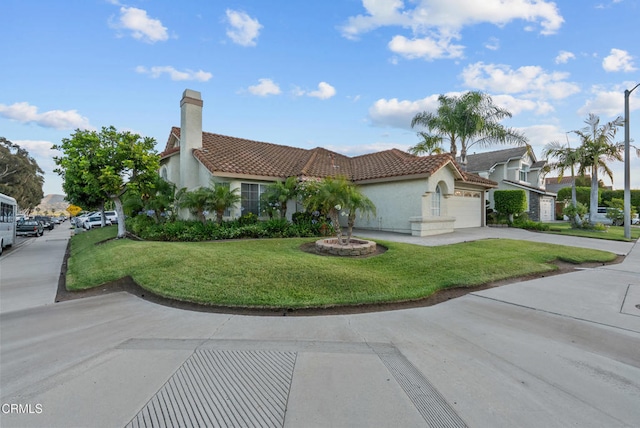 1306 Bluejay St, Fillmore, CA 93015 - mediterranean / spanish-style home featuring a tile roof, stucco siding, an attached garage, a front yard, and a chimney