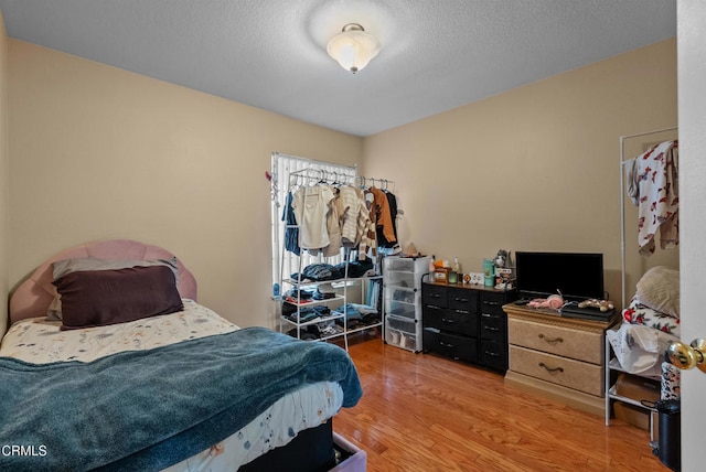 1306 Bluejay St, Fillmore, CA 93015 - bedroom with light wood finished floors and a textured ceiling