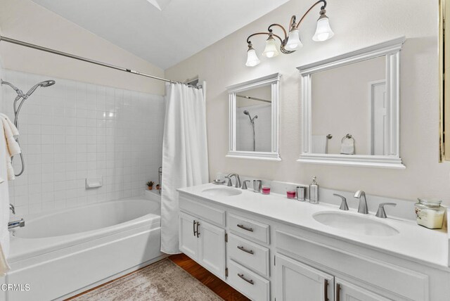 1306 Bluejay St, Fillmore, CA 93015 - bathroom featuring shower / tub combo, double vanity, lofted ceiling, and wood finished floors