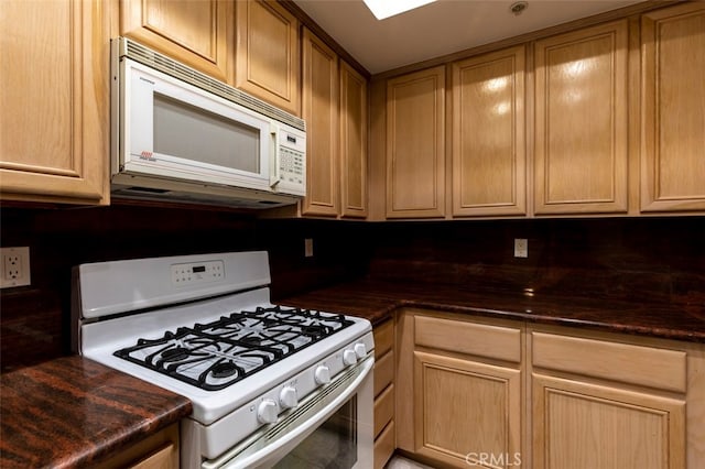 7218 Hillside Ave Unit 202, Los Angeles, CA 90046 - kitchen featuring white appliances and dark countertops