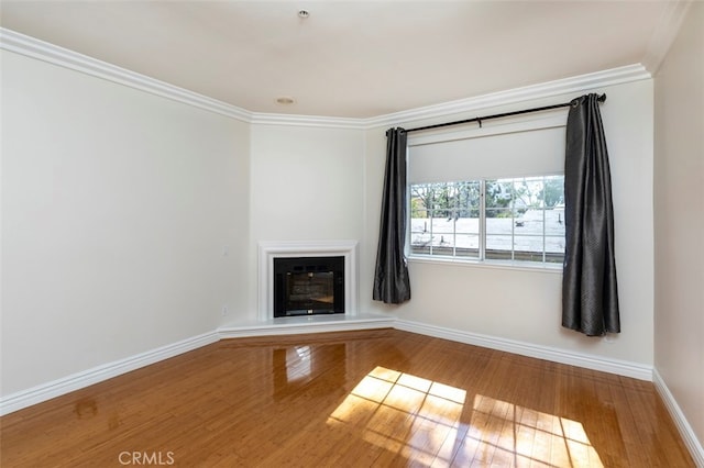 7218 Hillside Ave Unit 202, Los Angeles, CA 90046 - unfurnished living room featuring wood finished floors, ornamental molding, and a glass covered fireplace