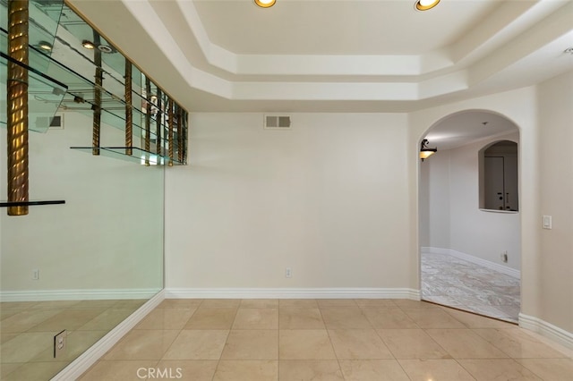7218 Hillside Ave Unit 202, Los Angeles, CA 90046 - spare room with a raised ceiling, arched walkways, recessed lighting, and tile patterned flooring