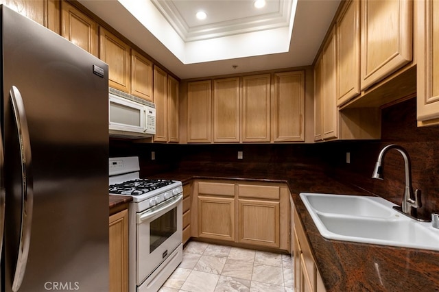 7218 Hillside Ave Unit 202, Los Angeles, CA 90046 - kitchen with white appliances, dark countertops, a raised ceiling, ornamental molding, and recessed lighting