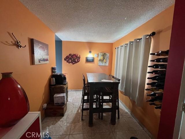 3804 Broadway Unit 3804, Huntington Park, CA 90255 - tiled dining space featuring a textured ceiling